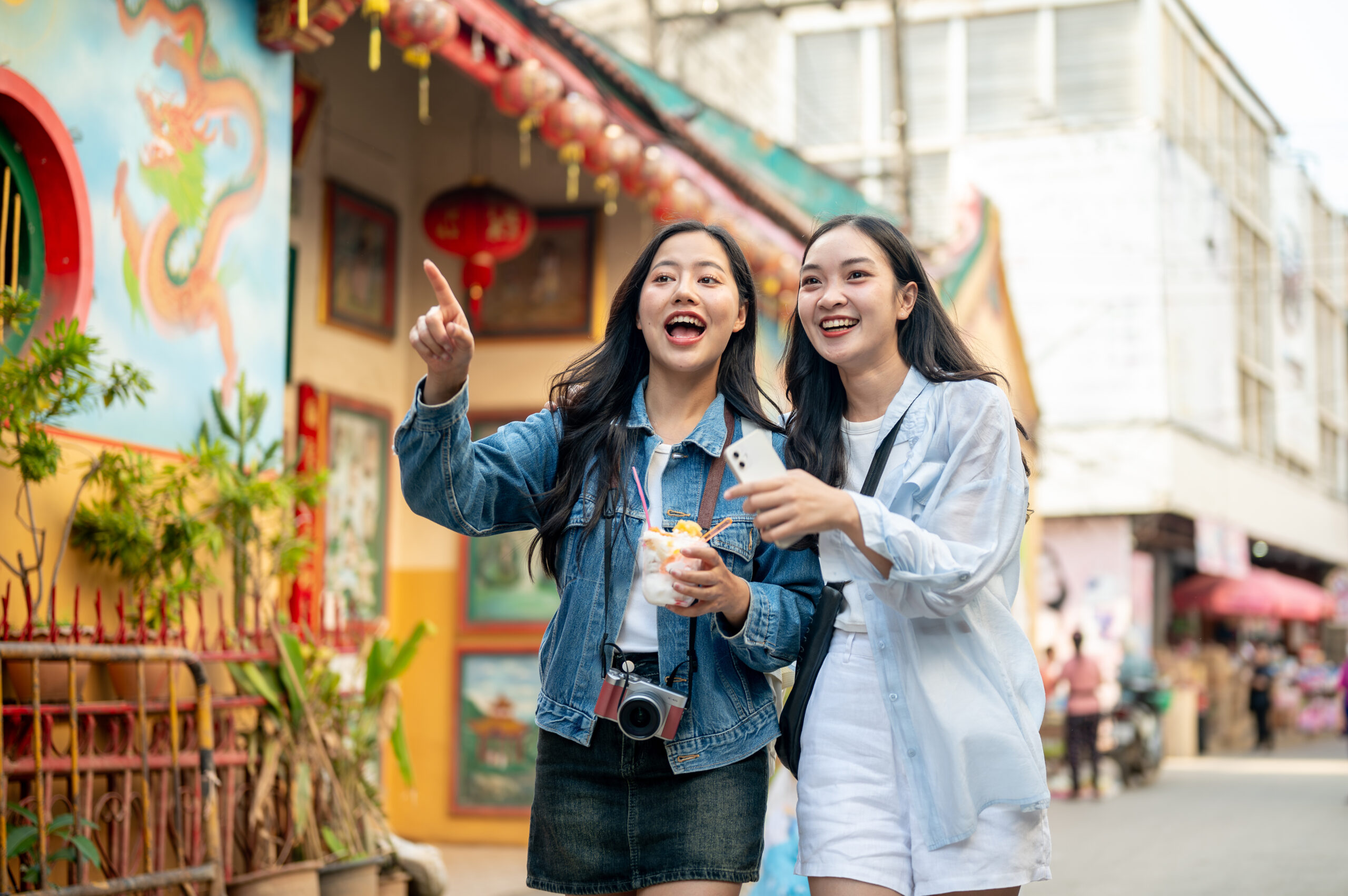 two asian women exploring Thailand city