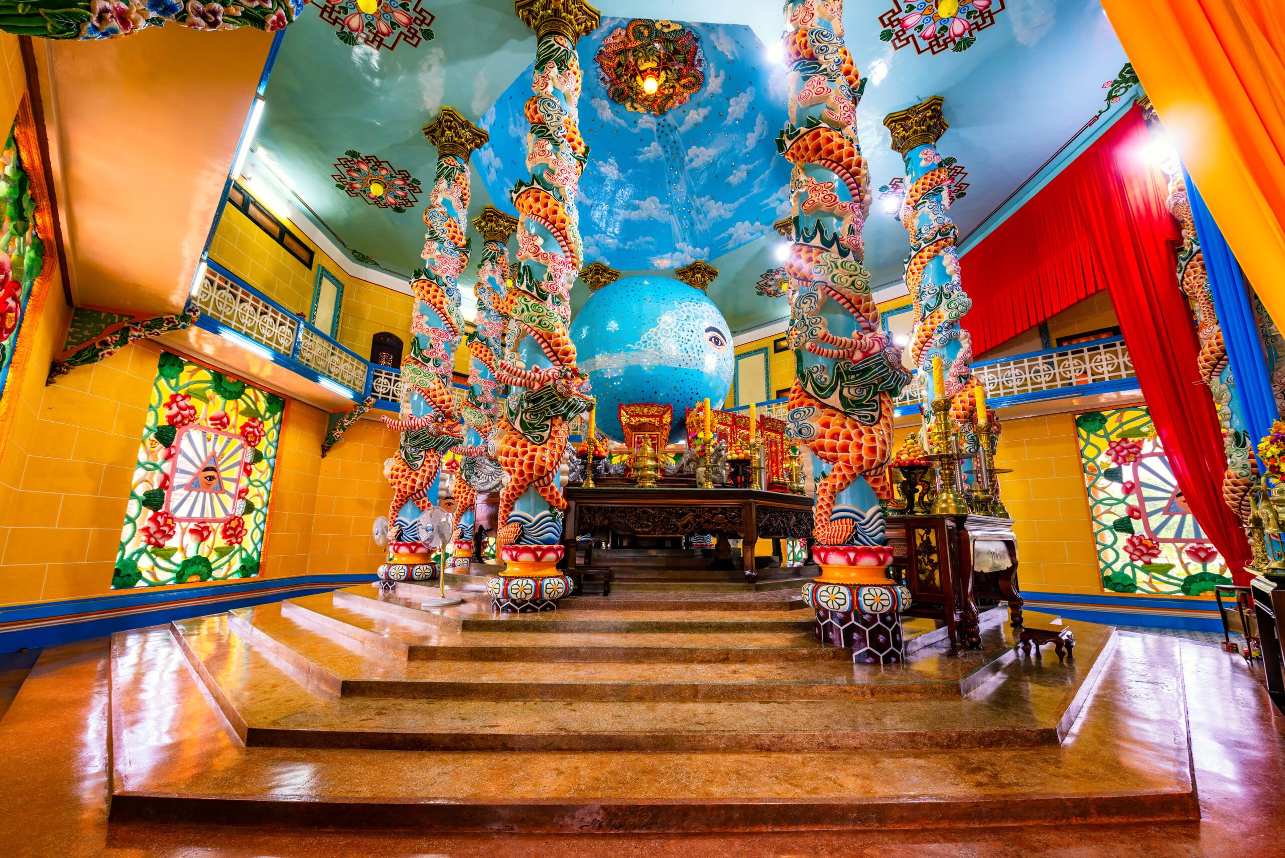 poles and decorations inside of Cao Dai temple in Tay Ninh, Vietnam