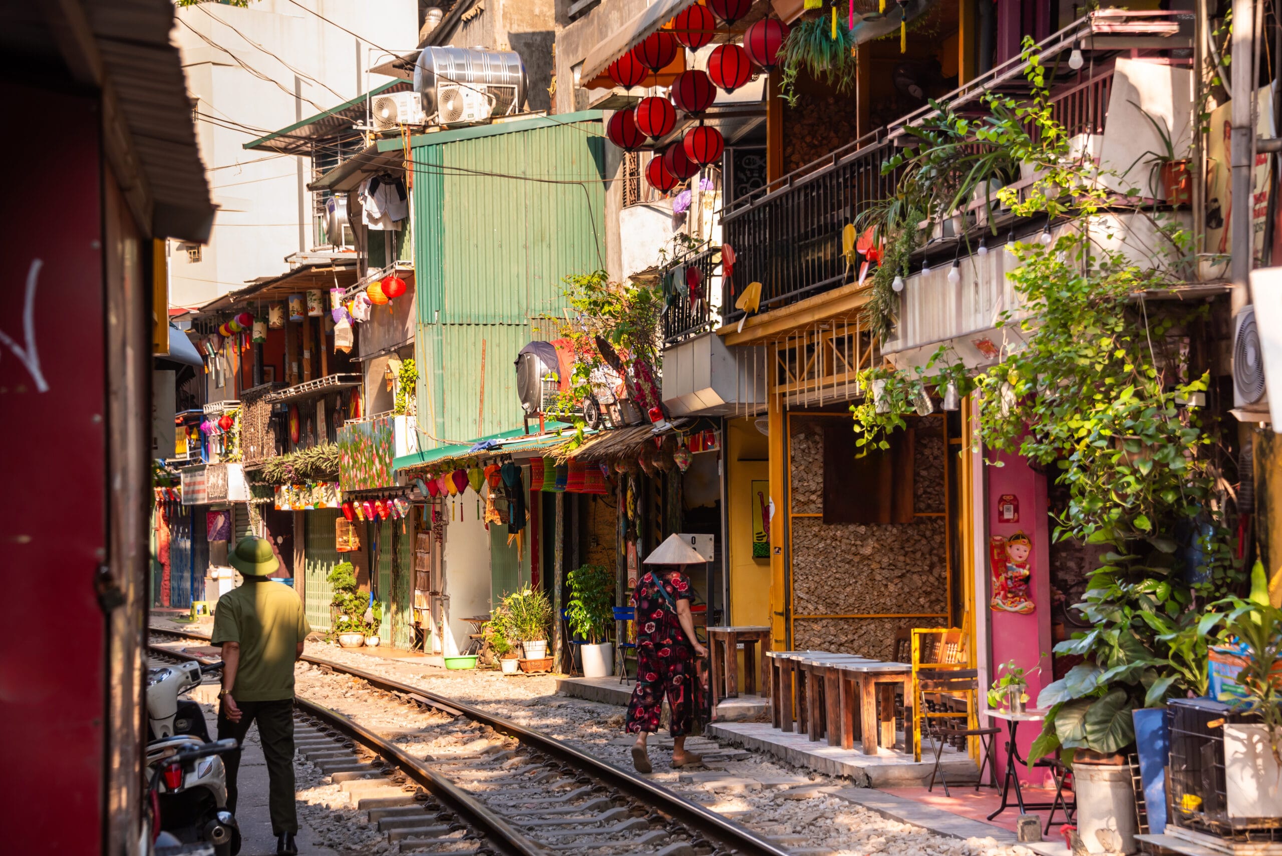 woman walks into building near of the train street in Ha Noi
