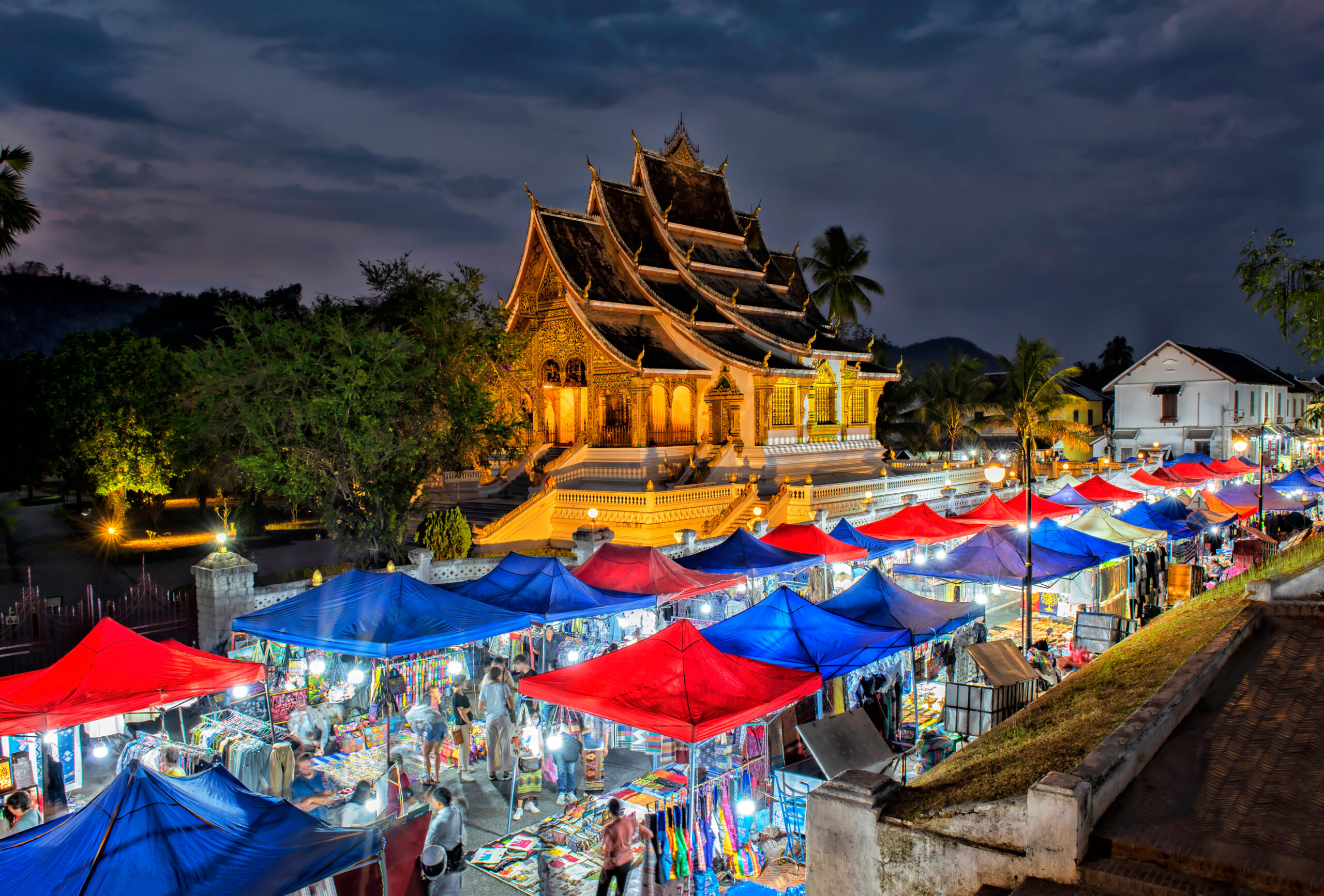lighted portable canopies with vendors selling goods along the streets of Luang Prabang Night Market, Laos