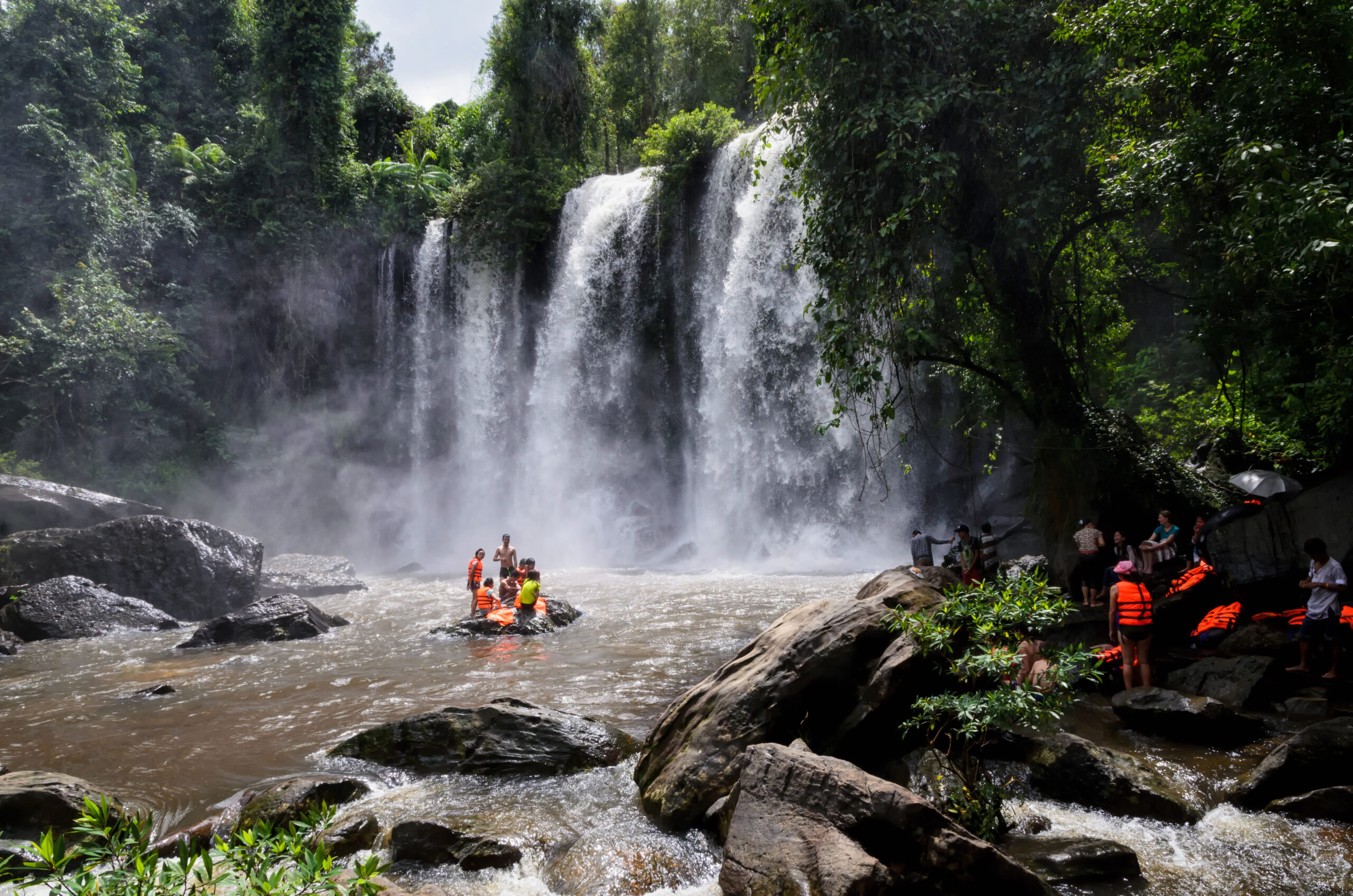 locals swimming at Phnom Kulen waterfall in Phnom Kulen National Park, Cambodia