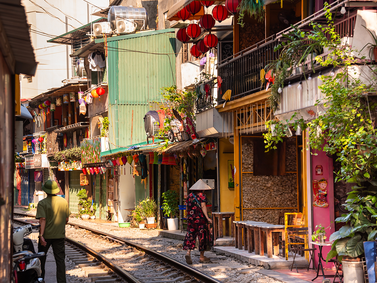 AP_0000_AdobeStock_758031630 Hanoi Old Quarter Vietnam narrow street with shops, scooters, and historic architecture