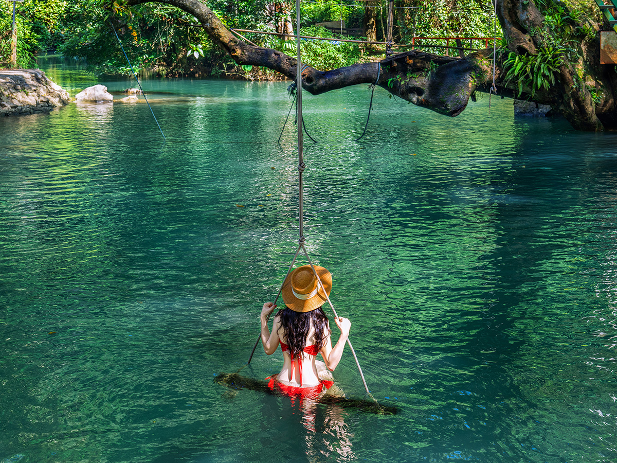Laos_Blue Lagoon Young Asian tourists enjoying the Blue Lagoon in Vang Vieng, Laos