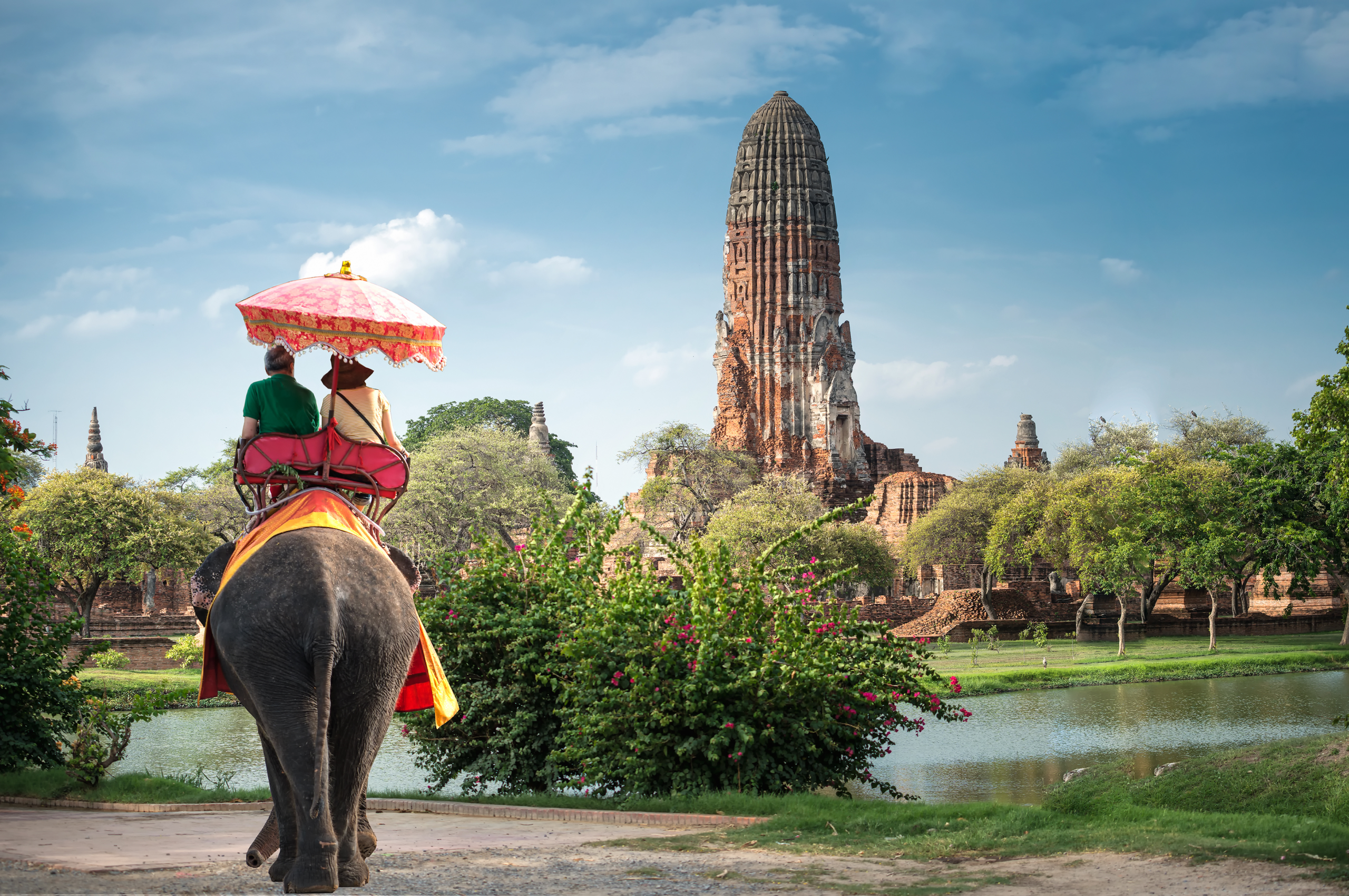 Tourists on an elephant ride tour of the ancient city Ayutaya, Thailand