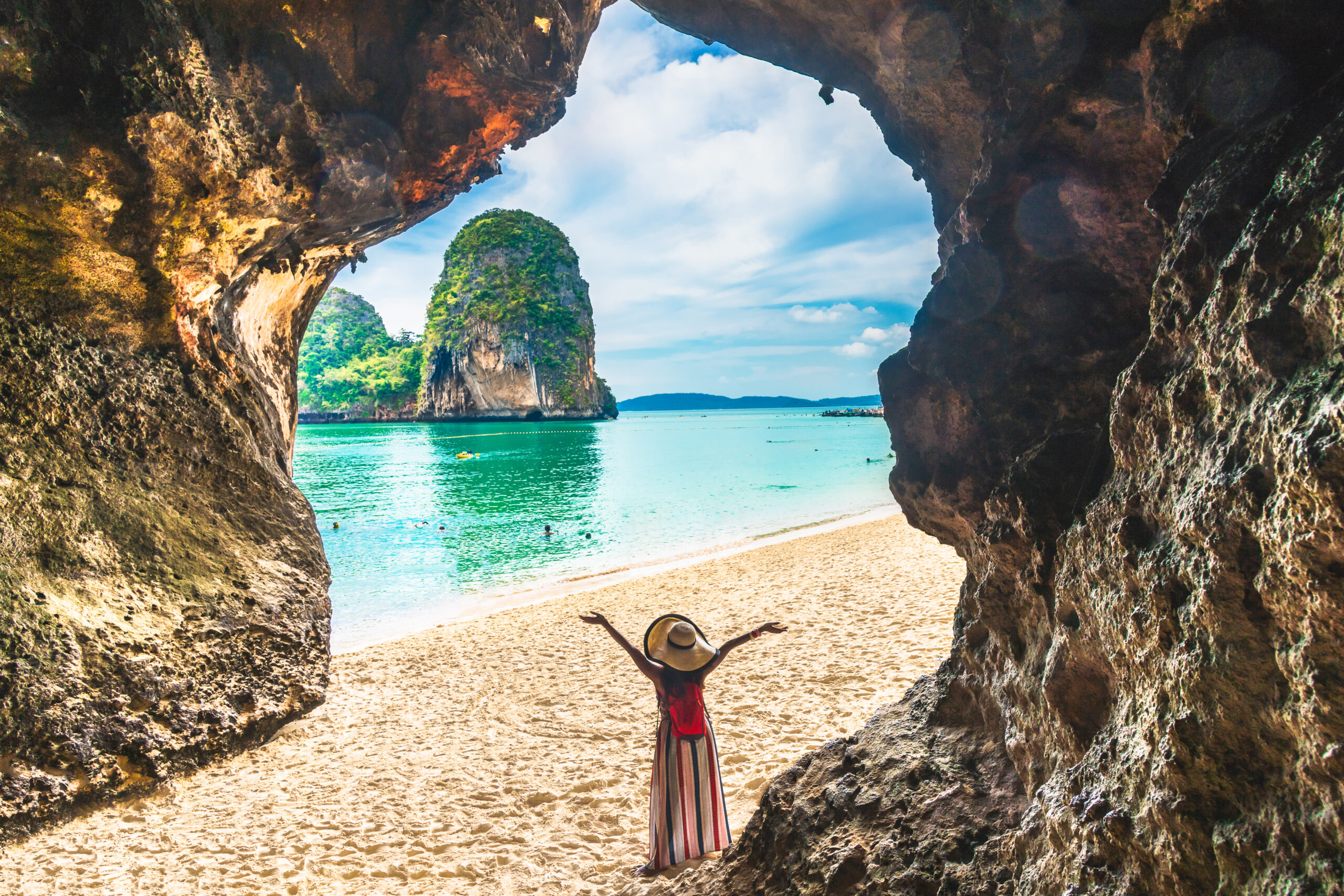Landscape of Phra Nang cave beach, Traveler woman joy relaxing on sand beach, Ao Nang beach, Krabi, Thailand